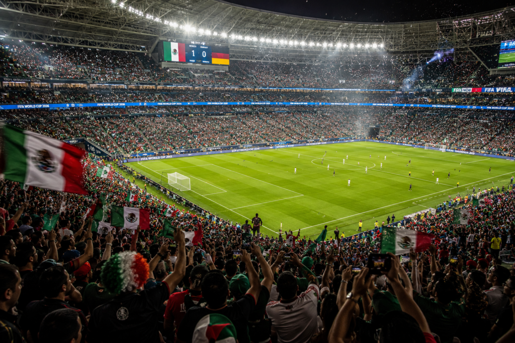 A packed stadium crowd cheering during a match, featured as a visual asset for a FIFA World Cup 2026 live hub