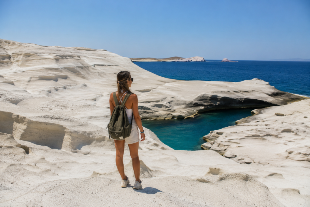 An independent traveler exploring the volcanic landscape of Milos as one of the best day trip alternatives to popular tourist sites.