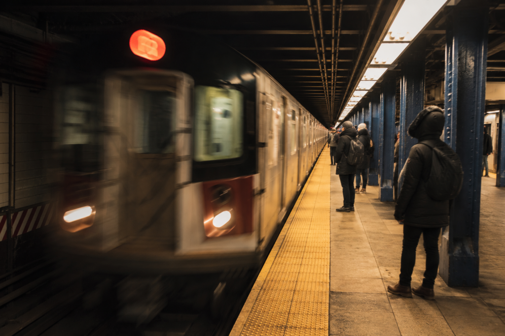 New York on a budget guide — subway platform representing the transit system that makes outer-borough neighborhoods practical