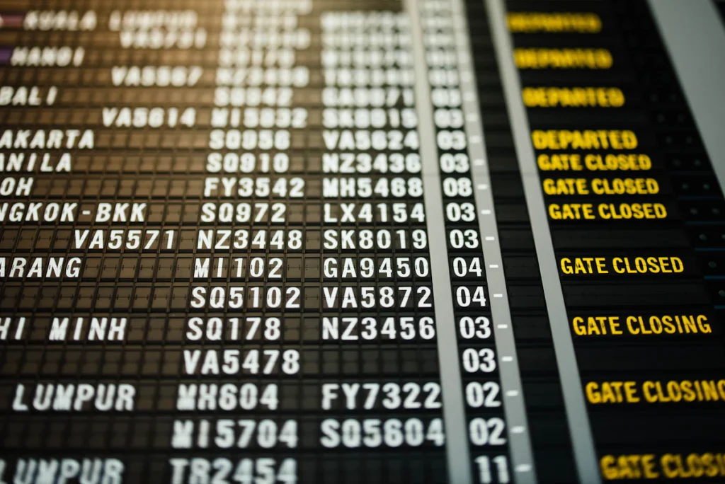 Airport departures board showing gate closing and gate closed notices